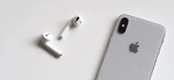 A pair of Apple AirPods next to an iPhone