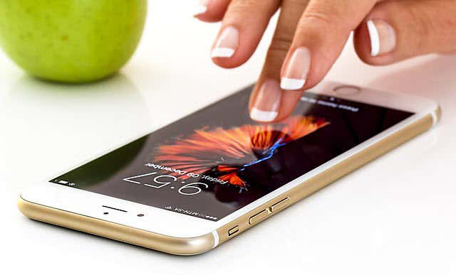 Woman's hand tapping an iPhone