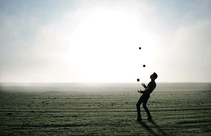 A man juggling on the sand