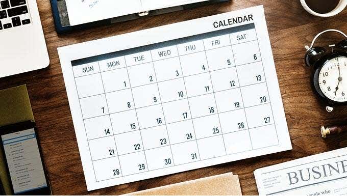 Physical calendar on a wooden desktop
