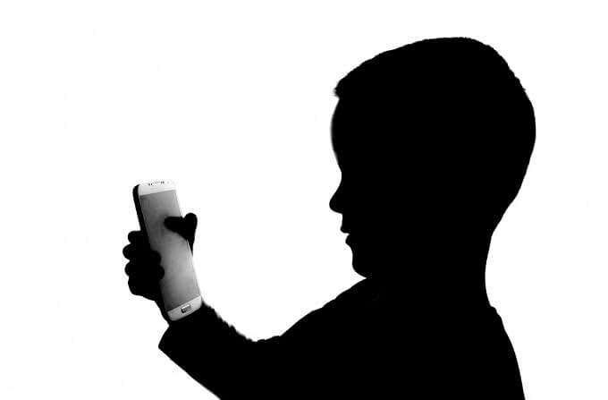 Silhouette of child holding iPod Touch 
