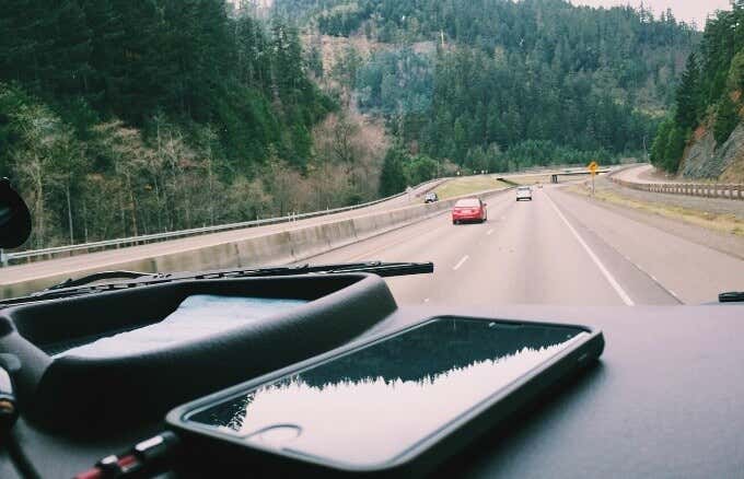 iPhones sitting on a car dashboard 