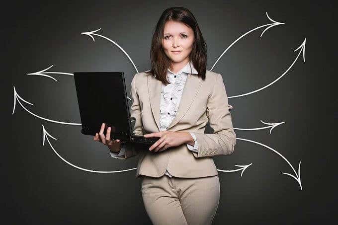 Woman holding laptop surrounded by arrows 