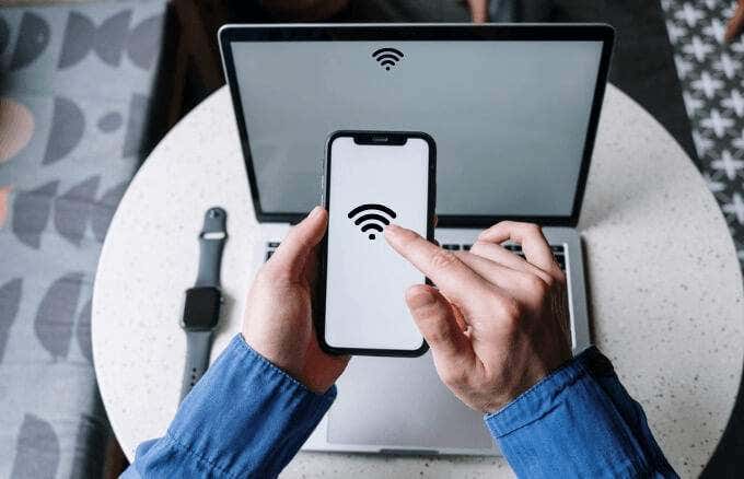 Someone connecting an iPhone to a Mac using wifi