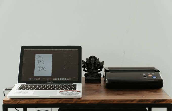 Mac laptop on desk with printer 