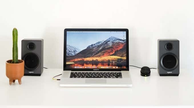 A MacBook with a pair of speakers 