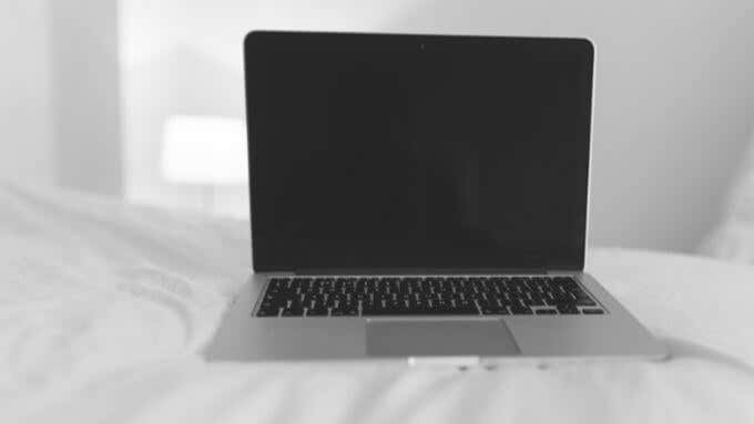Mac laptop on a bed