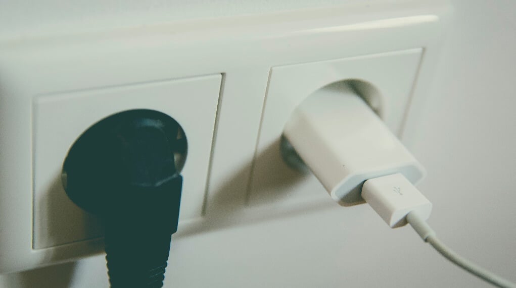 AirPods charging in a wall socket