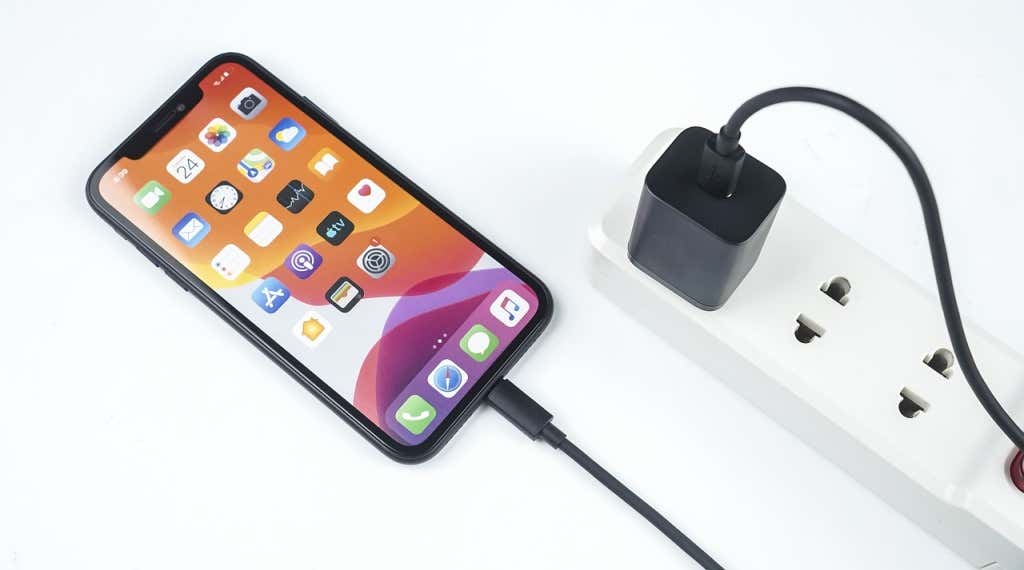 An iPhone plugged into a power strip