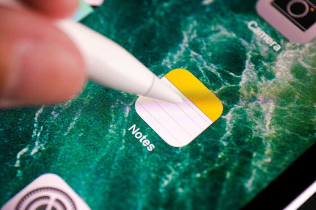 Someone touching the Notes app with an Apple Pencil 