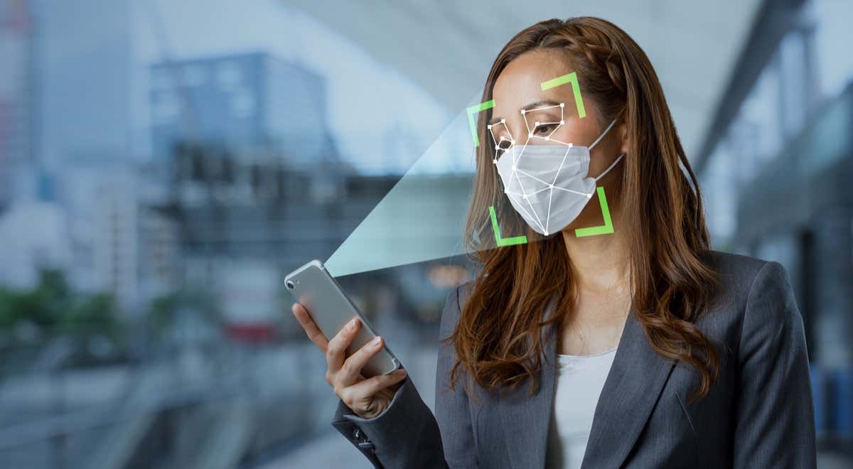 Someone using Face ID while wearing a mask