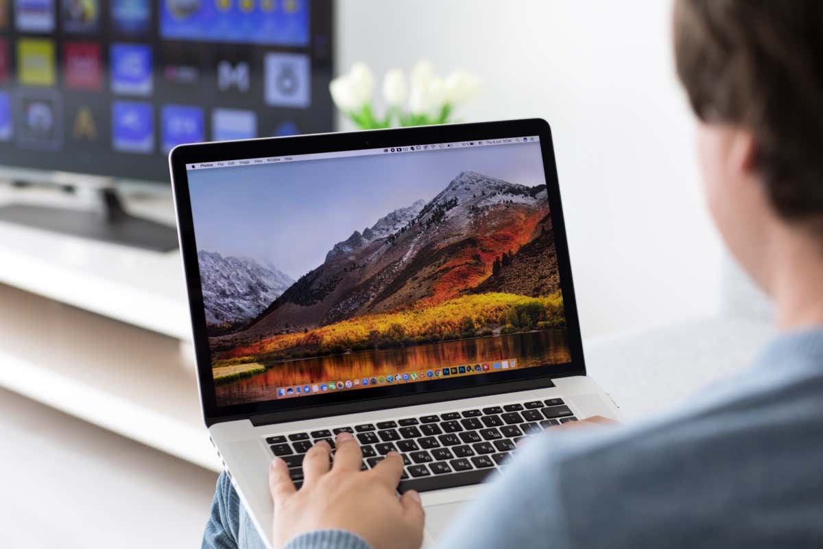 Someone connecting a MacBook to a TV