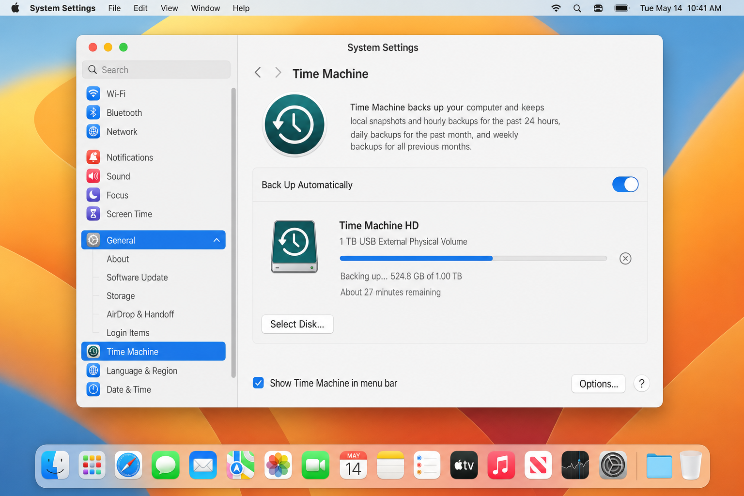 macOS System Settings > General > Time Machine pane showing a backup in progress with the progress bar, estimated time remaining, and Back Up Automatically toggle switched on