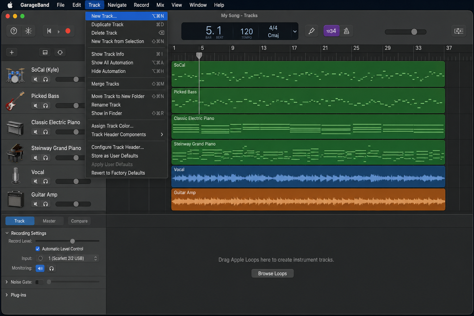 GarageBand menu bar with the Track menu open and New Track option highlighted