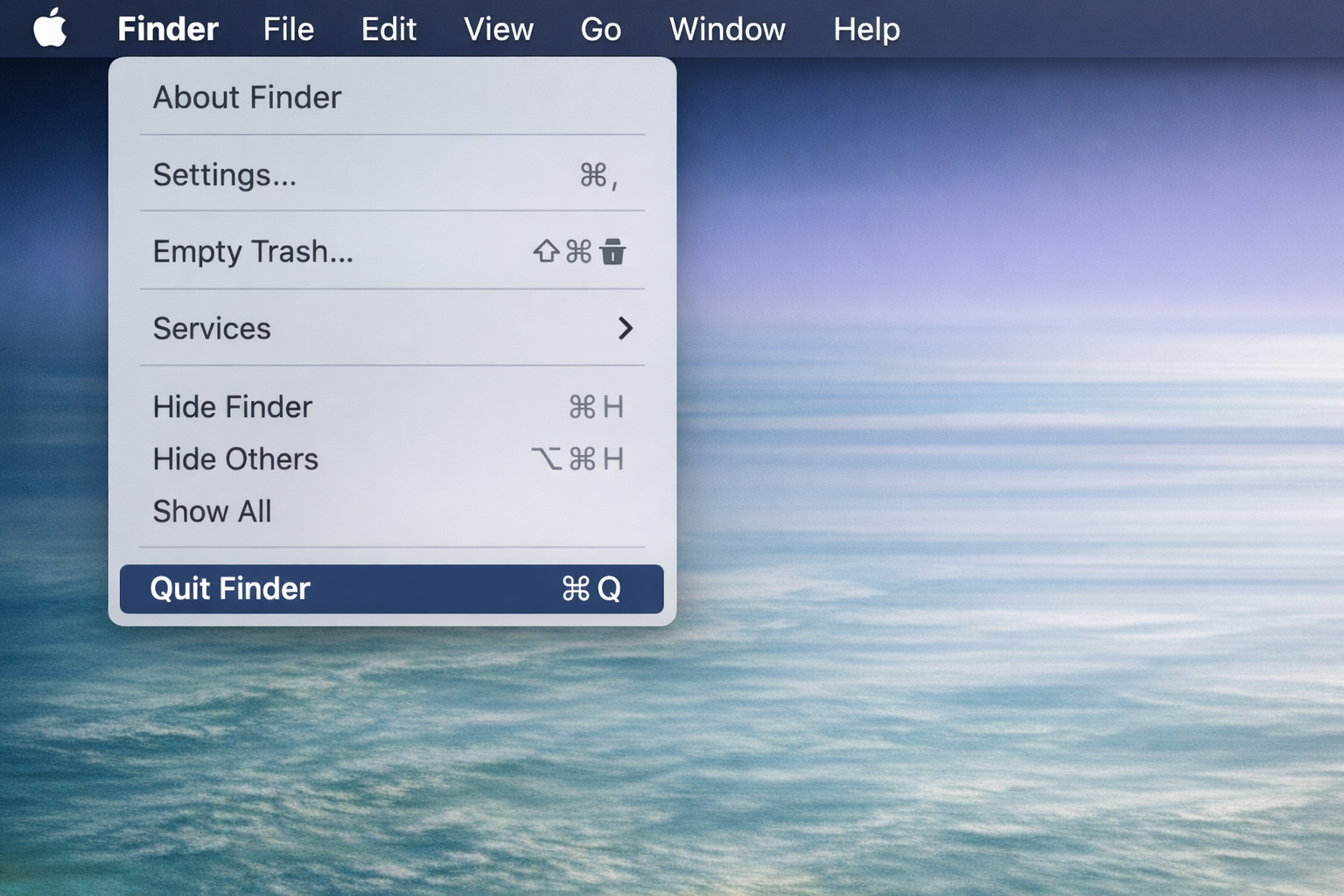 Finder menu bar with the Finder menu open, showing the Quit Finder option at the bottom of the menu alongside its Cmd+Q keyboard shortcut