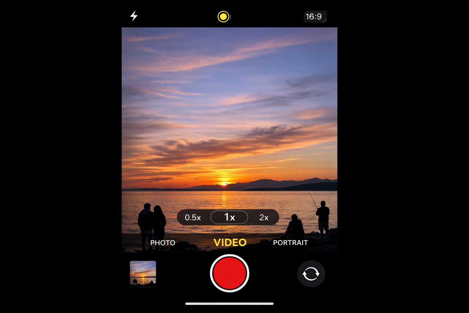 iPhone Camera app open in video mode showing the lens selection buttons (0.5x, 1x, 2x) at the bottom of the viewfinder