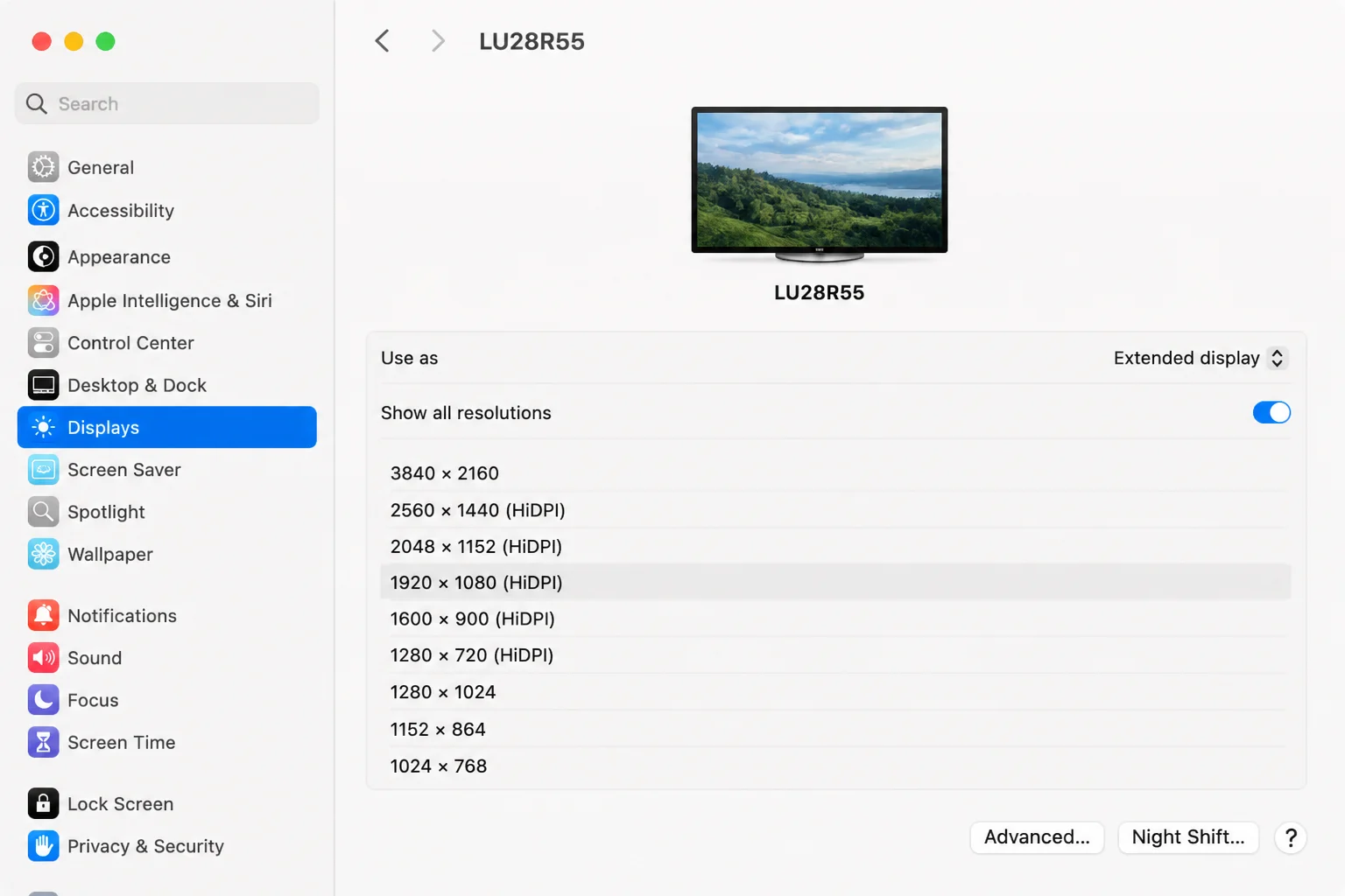 Selected external monitor in System Settings Displays with resolution choices and Show all resolutions control visible